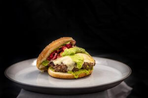 Shows the assembled burger on a black background